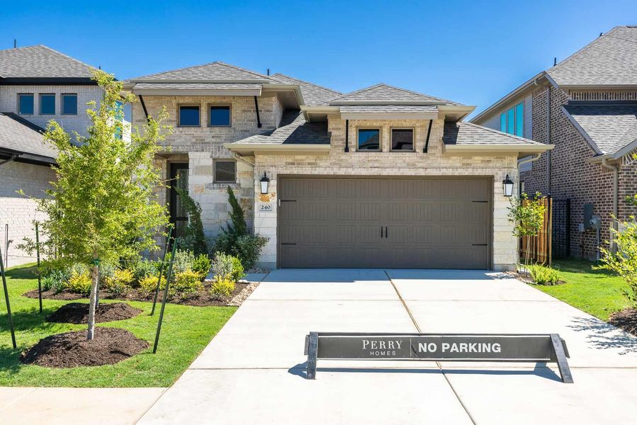 Prairie-style home featuring concrete driveway, a shingled roof, stone siding, and an attached garage Prairie-style home featuring concrete driveway, a shingled roof, stone siding, and an attached garage