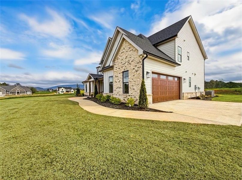 Front exterior of a new home in , Rydal, GA, highlighting curb appeal (Image 1). Front exterior of a new home in , Rydal, GA, highlighting curb appeal (Image 1).