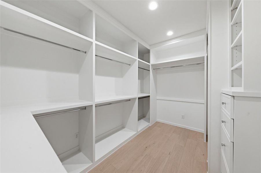 This spacious walk-in closet offers abundant storage and thoughtful organization with room for every wardrobe essential.