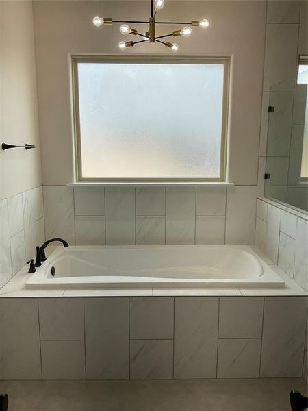 Large soaking tub in primary bathroom