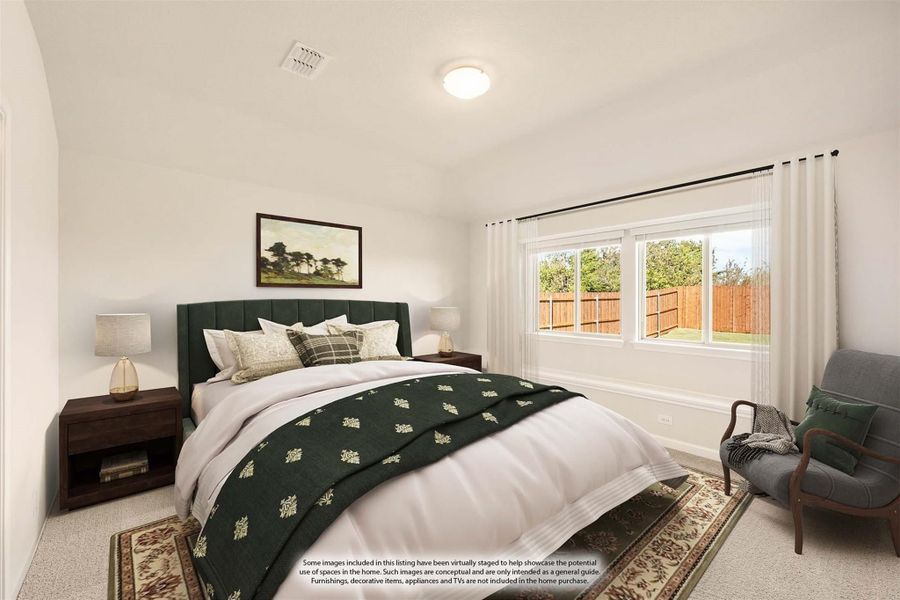 Bedroom with green upholstered bed, carpet flooring, and large window with backyard view