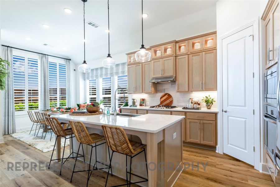 Kitchen with backsplash, decorative light fixtures, light wood-type flooring, healthy amount of natural light, and recessed lighting Kitchen with backsplash, decorative light fixtures, light wood-type flooring, healthy amount of natural light, and recessed lighting