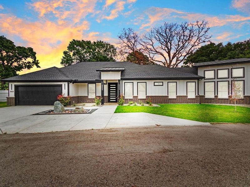 Contemporary single-story residence featuring a dark asphalt shingle roof and white vertical siding