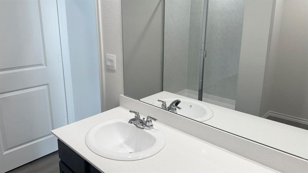 Bathroom featuring vanity and a textured wall