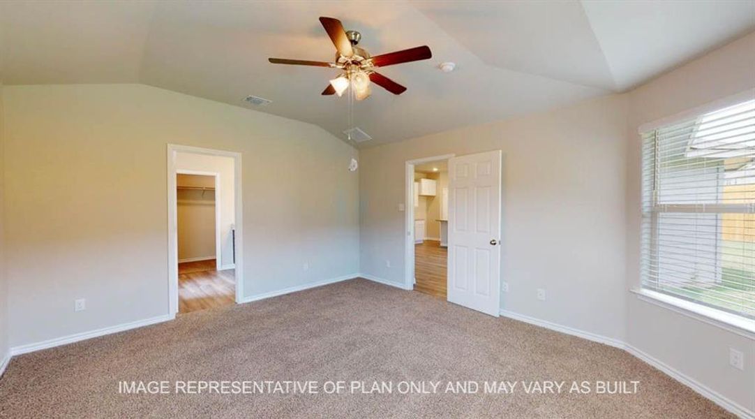 Unfurnished bedroom with lofted ceiling, a spacious closet, light colored carpet, and a ceiling fan Unfurnished bedroom with lofted ceiling, a spacious closet, light colored carpet, and a ceiling fan