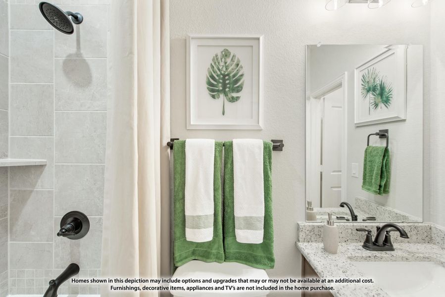 Bathroom with tiled walk-in shower, granite vanity, large mirror, and towel bar with green and white towels. Bathroom with tiled walk-in shower, granite vanity, large mirror, and towel bar with green and white towels.