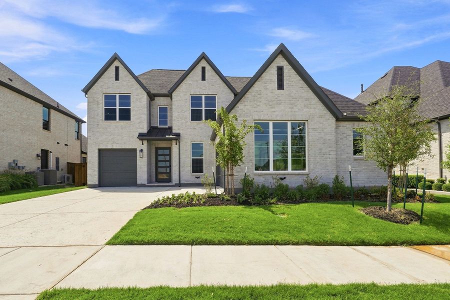 Front exterior of a new home in Estates at Rockhill, Frisco, TX, highlighting curb appeal (Image 1). Front exterior of a new home in Estates at Rockhill, Frisco, TX, highlighting curb appeal (Image 1).