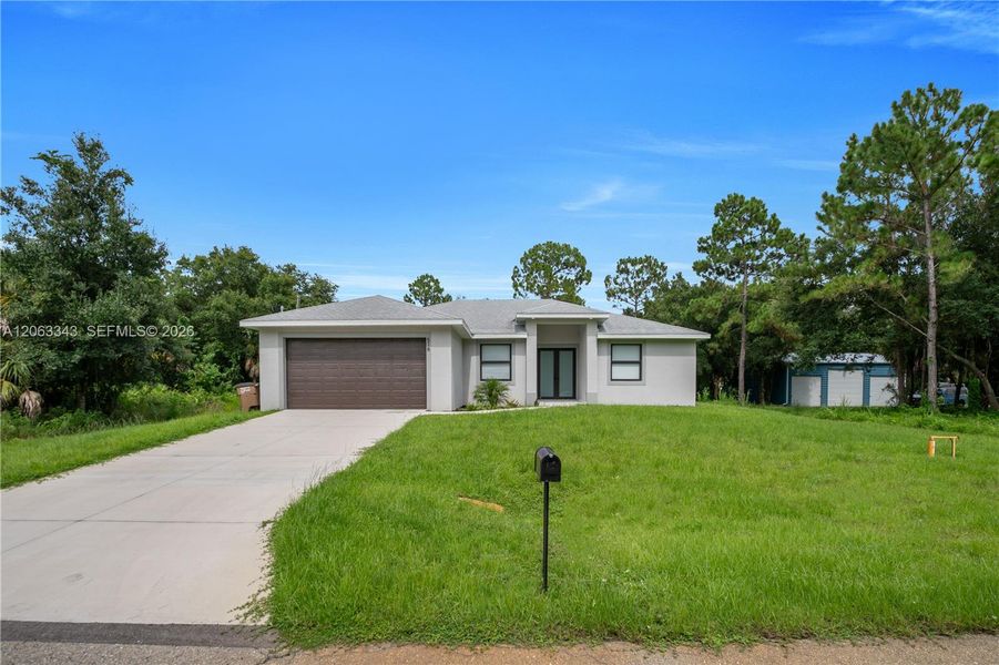 Front exterior of a new home in , Lehigh Acres, FL, highlighting curb appeal (Image 19). Front exterior of a new home in , Lehigh Acres, FL, highlighting curb appeal (Image 19).