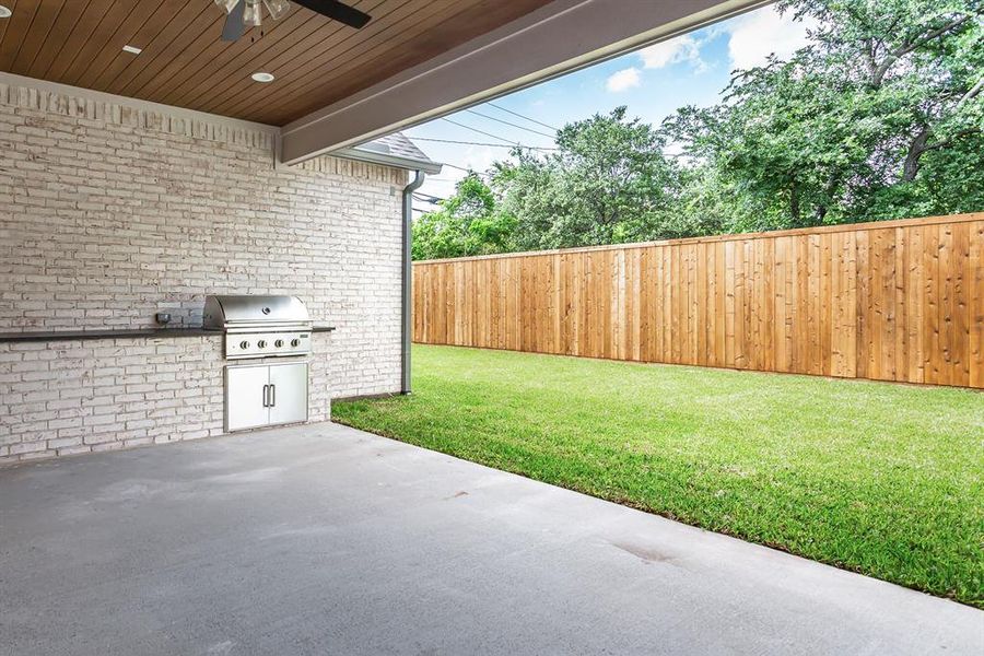 Back patio with wood ceiling, built in gas grill and beverage cooler