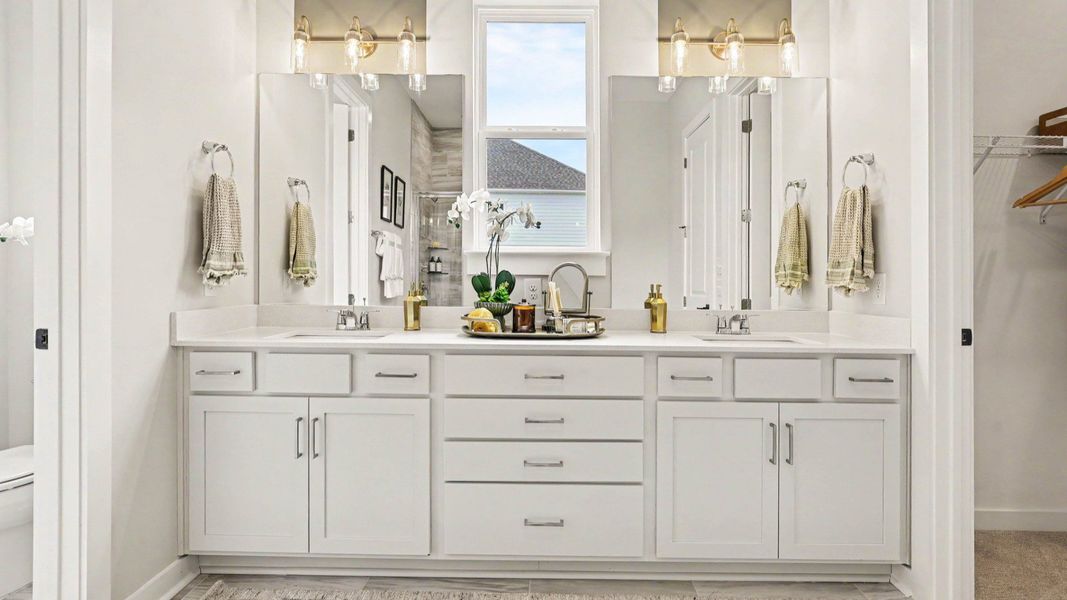 Primary bathroom with bright natural lighting and dual vanity