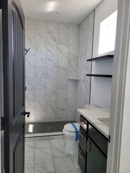A well-appointed bath features a tiled shower and vanity with contemporary fixtures. A well-appointed bath features a tiled shower and vanity with contemporary fixtures.