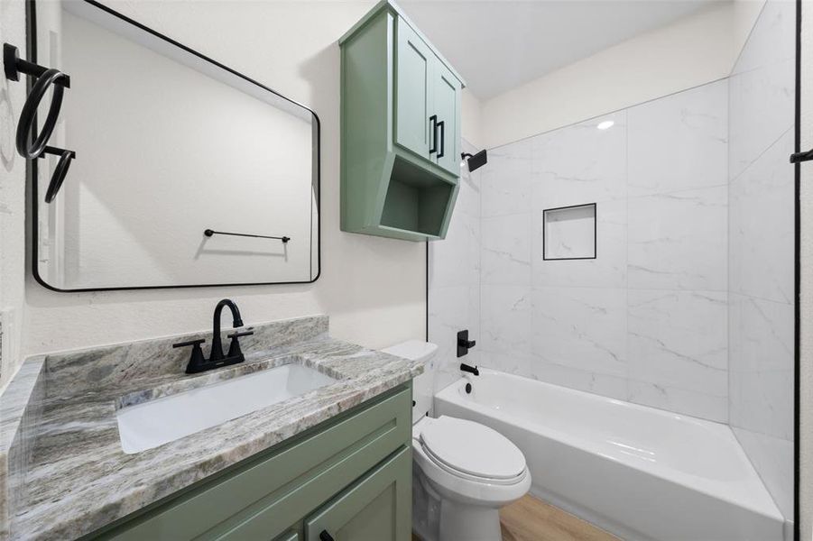Full bath with washtub / shower combination and vanity