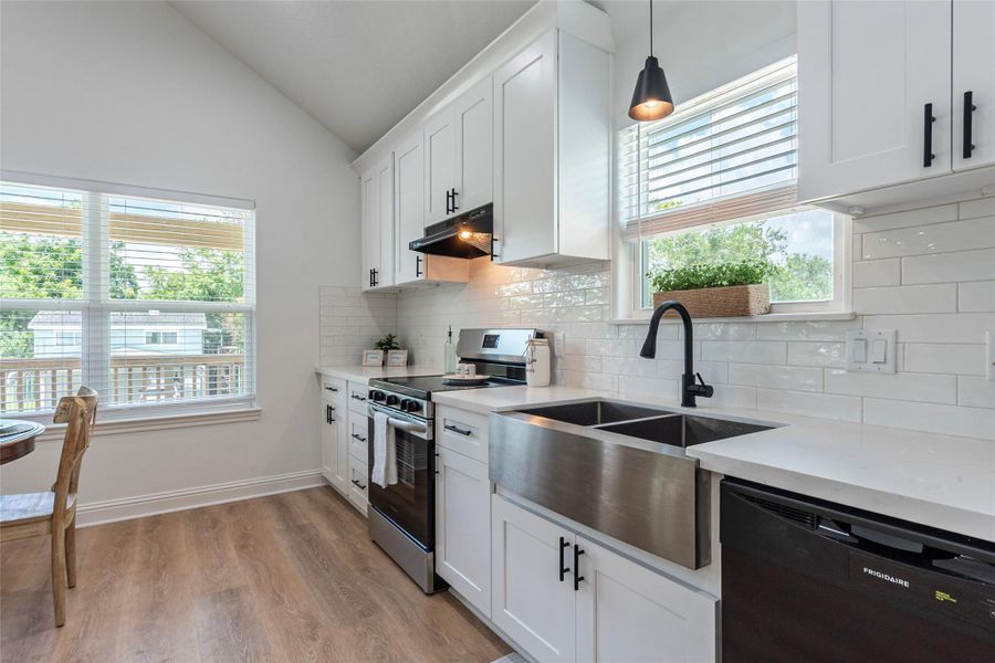 Beautiful kitchen with farmer's sink, soft closing cabinets and drawers, Quartz counter tops and more.