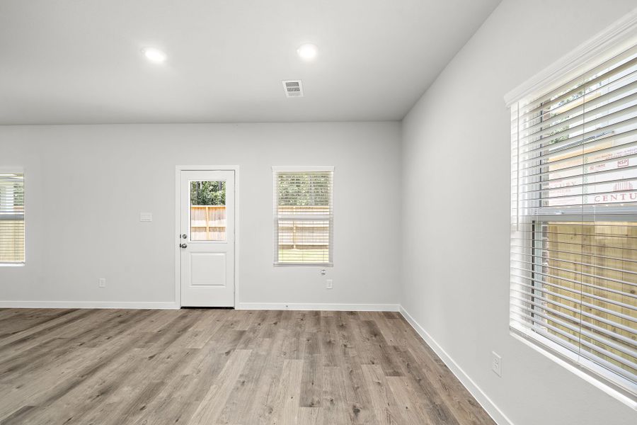 A room with a wood floor and a white door.