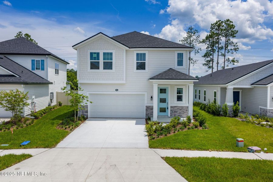 Front exterior of a new home in Beacon Lake, St. Augustine, FL, highlighting curb appeal (Image 22).