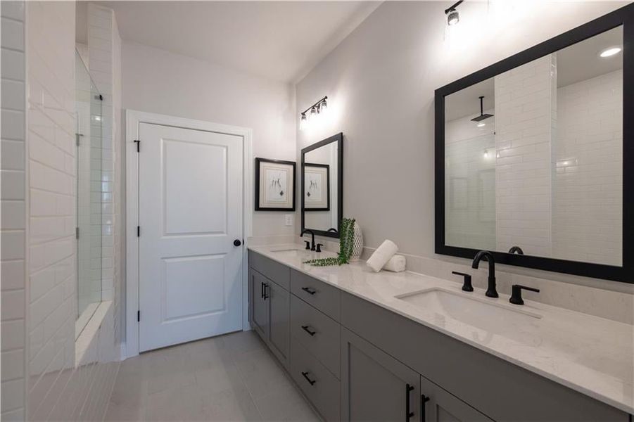 Double vanity with decorative mirrors. *Please note that pictures shown are of the Jacobsen II floorplan but they are not of the actual home listed.