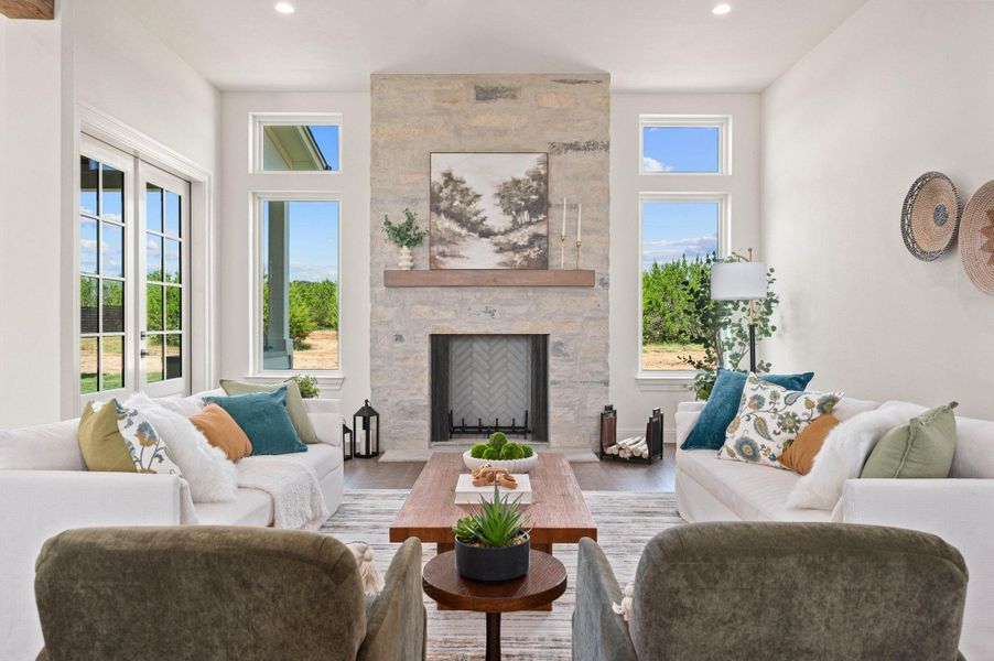 Living room featuring a stone fireplace, wood finished floors, and recessed lighting
