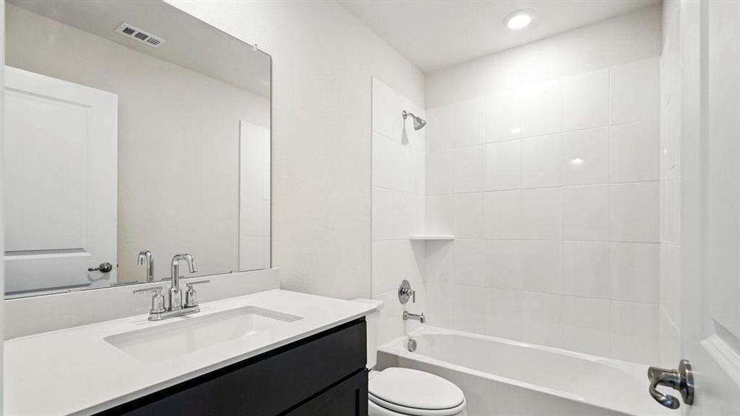 Bathroom featuring vanity, shower / bathtub combination, and recessed lighting Bathroom featuring vanity, shower / bathtub combination, and recessed lighting