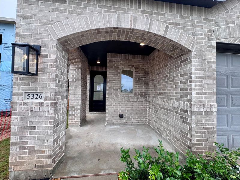 A cute front covered front porch to wave at your neighbors from!