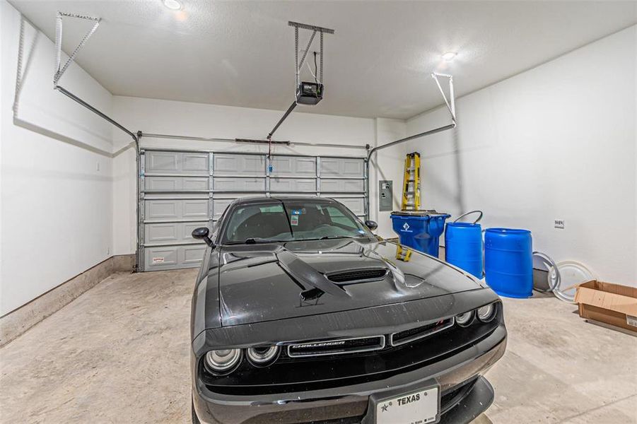 Garage with a garage door opener and electric panel