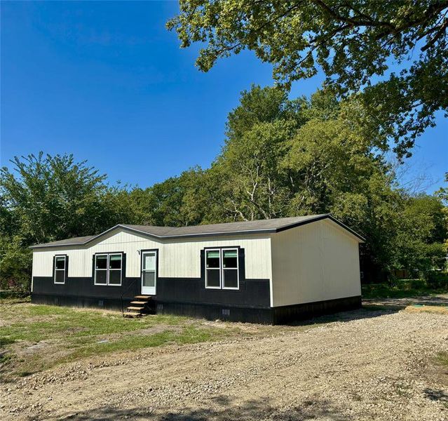 Front exterior of a new home in , Quinlan, TX, highlighting curb appeal (Image 22).