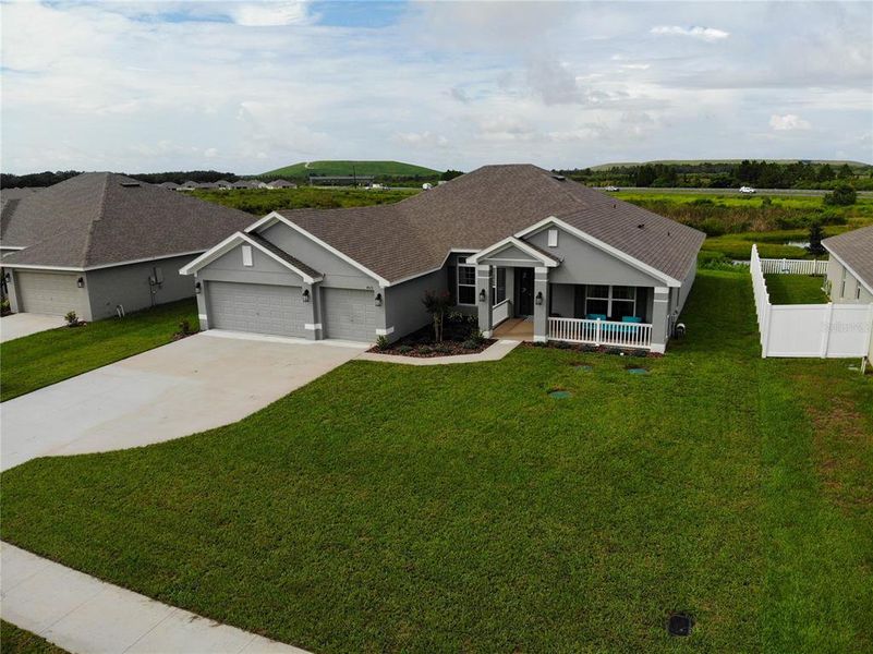Front exterior of a new home in Cadence Crossing, Auburndale, FL, highlighting curb appeal (Image 1).