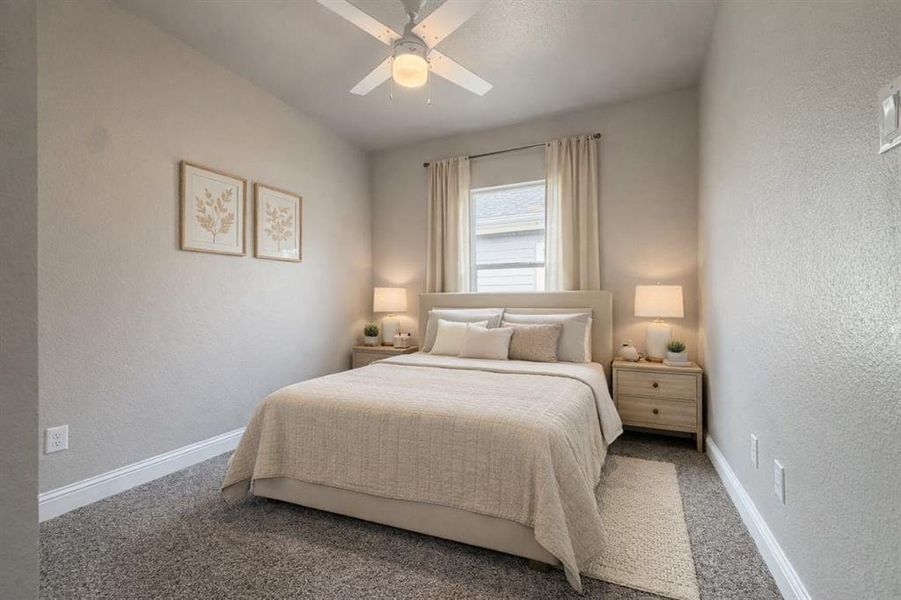 Bedroom with a textured wall, a ceiling fan, and carpet