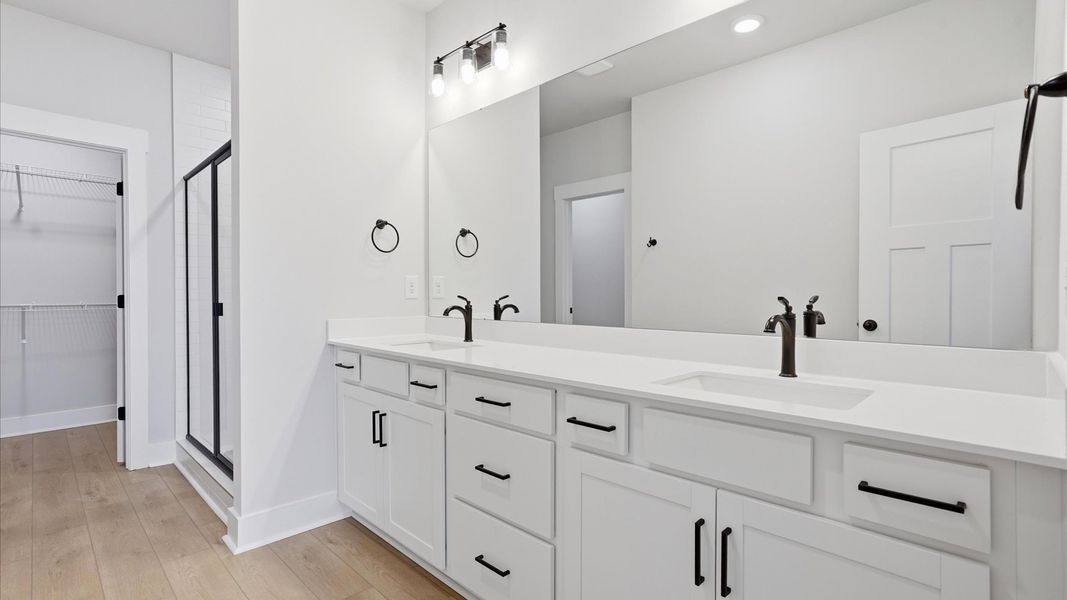 First-rate primary bathroom offering an elegant walk-in shower and dual sinks with superior style in Anderson, SC First-rate primary bathroom offering an elegant walk-in shower and dual sinks with superior style in Anderson, SC