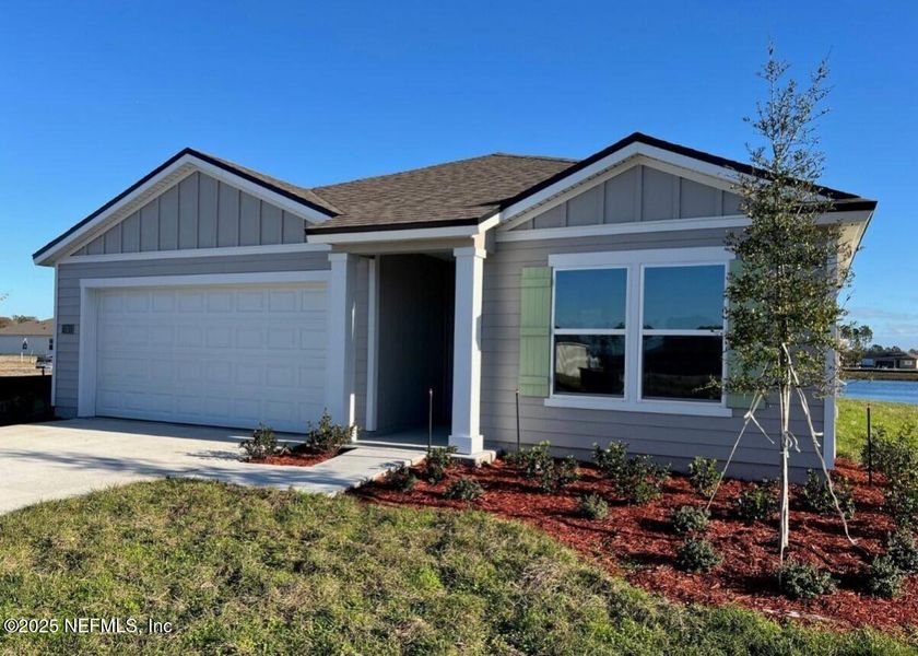 Front exterior of a new home in Sawmill Branch, Palm Coast, FL, highlighting curb appeal (Image 1). Front exterior of a new home in Sawmill Branch, Palm Coast, FL, highlighting curb appeal (Image 1).
