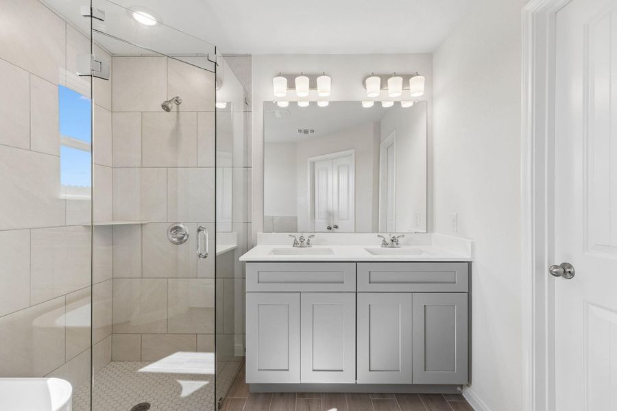 Clean lines and a spacious dual vanity define this modern, light-filled bathroom.