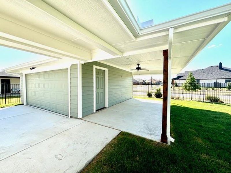 View of patio featuring ceiling fan and a garage