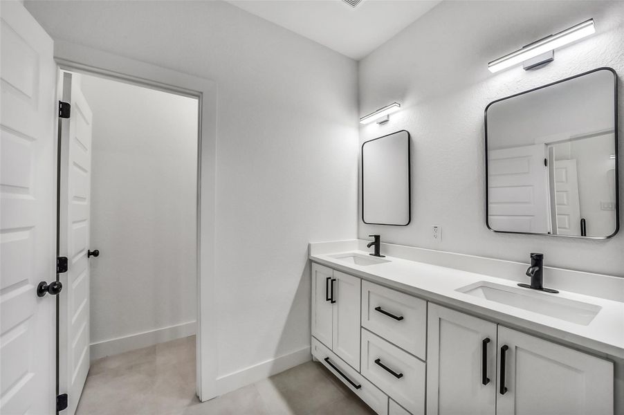 Primary Bathroom has a stylish dual vanity designed with convenience and functionality in mind.