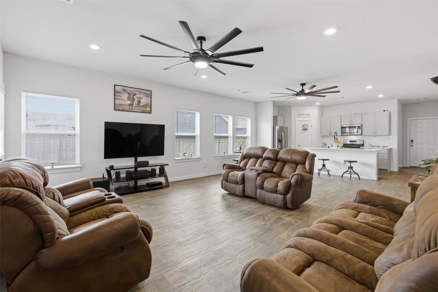 Living area featuring ceiling fan, recessed lighting, plenty of natural light, and light wood-type flooring