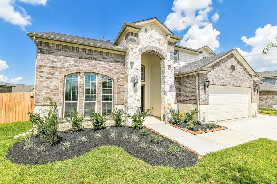Front exterior of a new home in Stone Creek Ranch, Hockley, TX, highlighting curb appeal (Image 24). Front exterior of a new home in Stone Creek Ranch, Hockley, TX, highlighting curb appeal (Image 24).