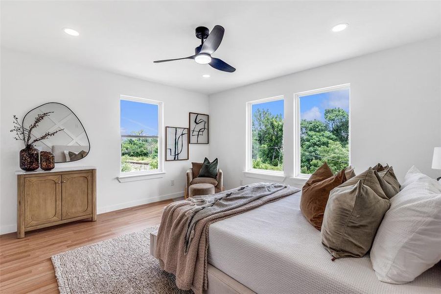 Bedroom featuring light wood-style flooring, recessed lighting, and a ceiling fan Bedroom featuring light wood-style flooring, recessed lighting, and a ceiling fan