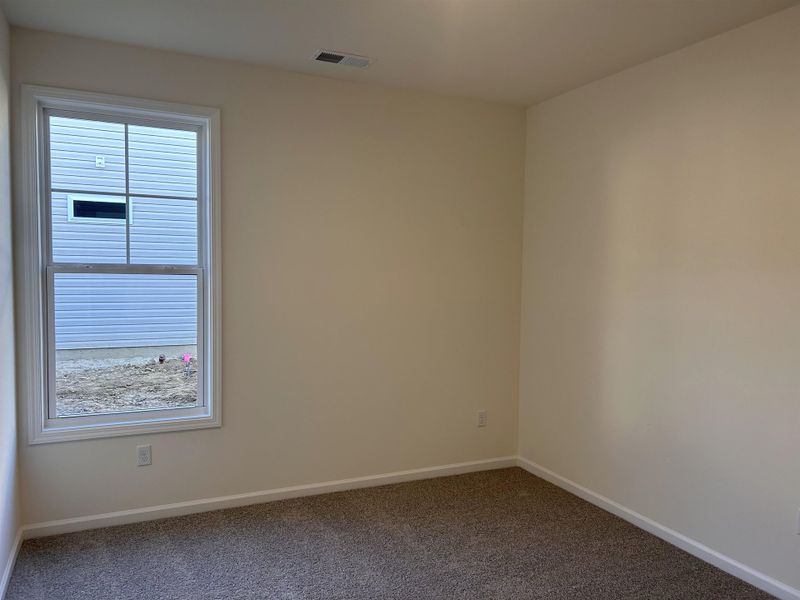 Carpeted empty room featuring baseboards