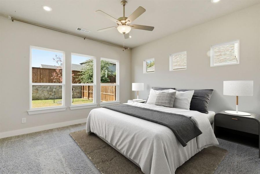 Carpeted bedroom featuring multiple windows, a ceiling fan, and recessed lighting
