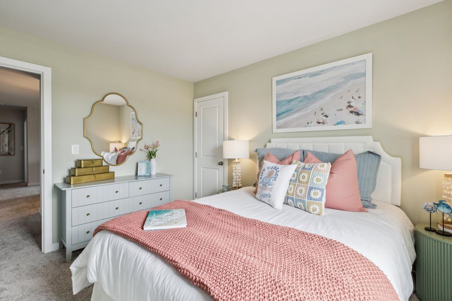 A bedroom with a bed and a mirror. A bedroom with a bed and a mirror.