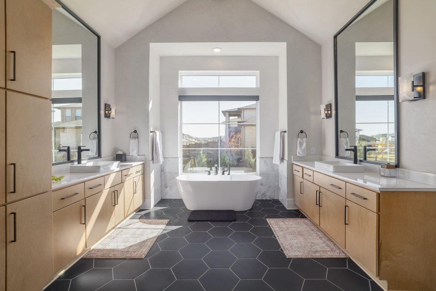 The spa-inspired primary bath includes dual vanities, a soaking tub, and refined finishes throughout.