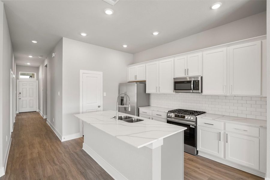 Oversized island provides extra seating and prep space — ideal for family meals or casual entertaining. Oversized island provides extra seating and prep space — ideal for family meals or casual entertaining.