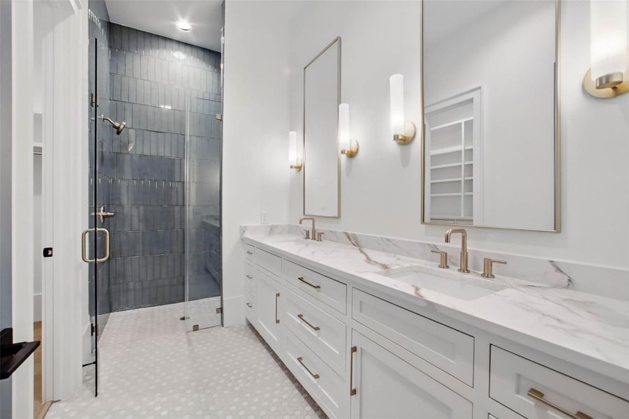 Sample of builder's previous construction. This home will have a downstairs guest suite w/ a large bath w/ double sinks.  Buyer still has time to select finishes.