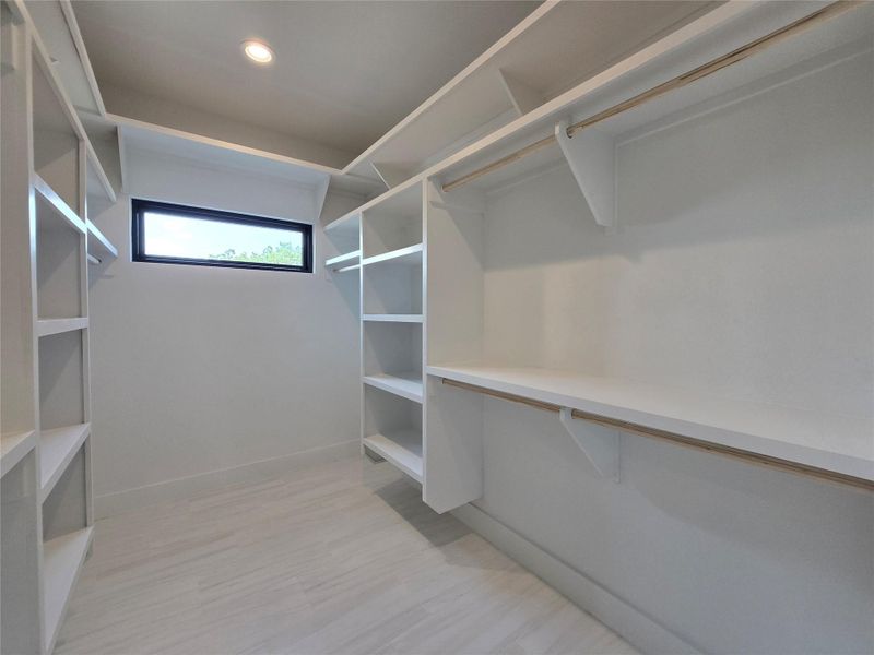 Spacious closet featuring light wood-type flooring Spacious closet featuring light wood-type flooring