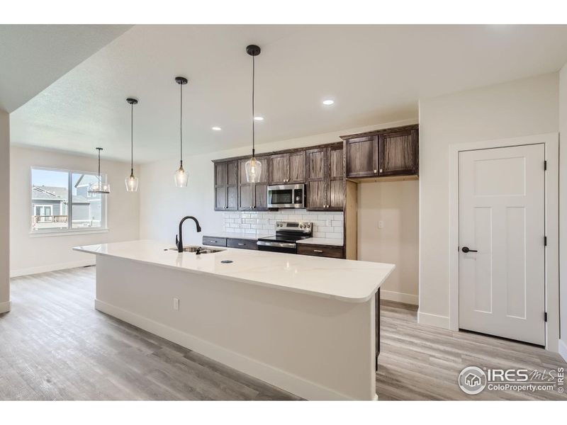 Open concept with island and built in pantry.