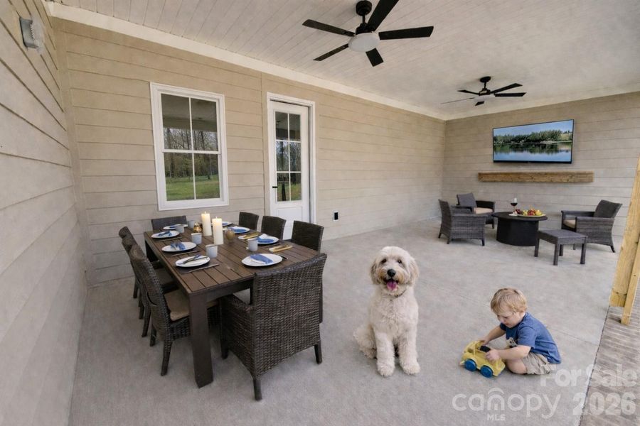 Back concrete Patio is covered. The tv and fireplace are virtually staged.