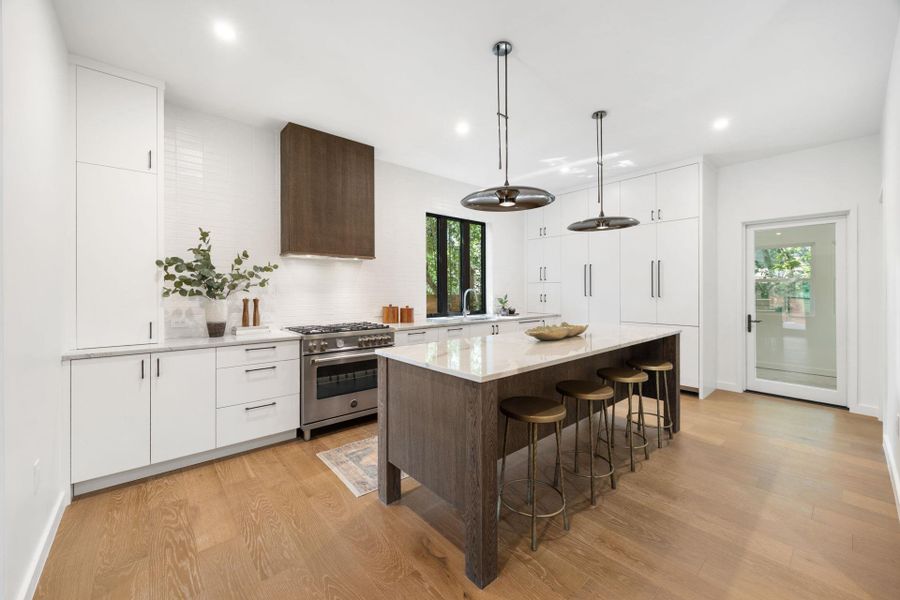 Kitchen with dark brown cabinetry, white cabinets, modern cabinets, and recessed lighting