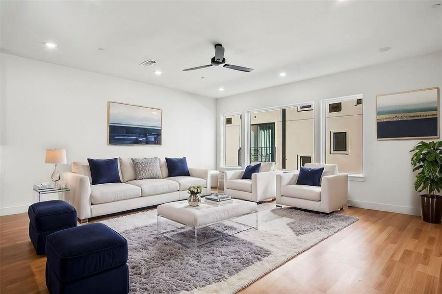 Living room with hardwood floors and ceiling fan