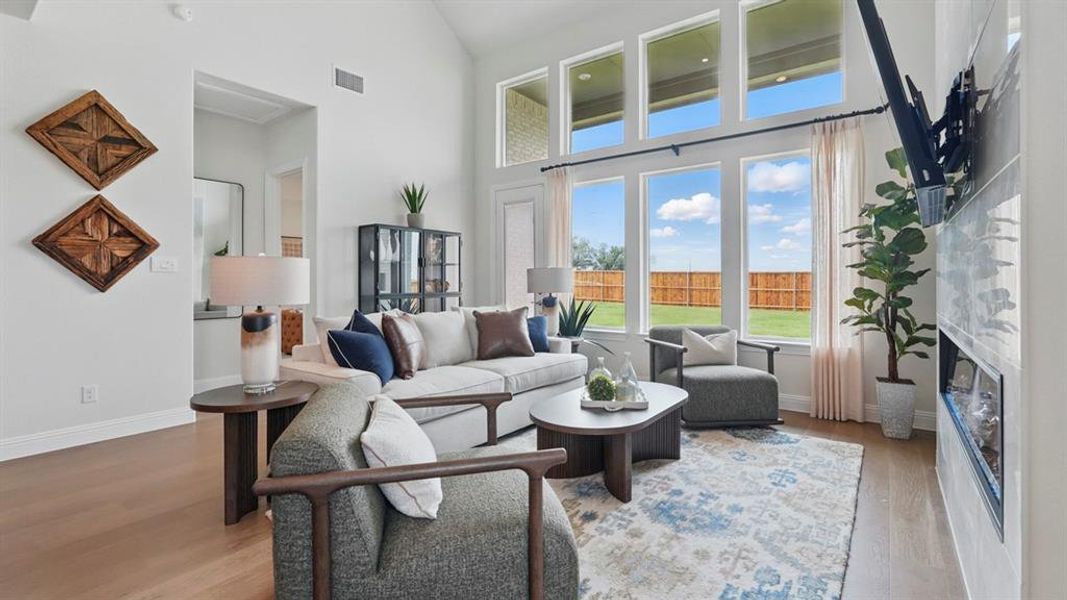 Expansive living area featuring a vaulted ceiling and wood-finish flooring