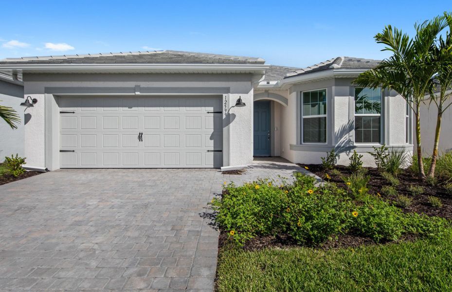 Front exterior of a new home in TerraWalk at Babcock Ranch, Alva, FL, highlighting curb appeal (Image 1).