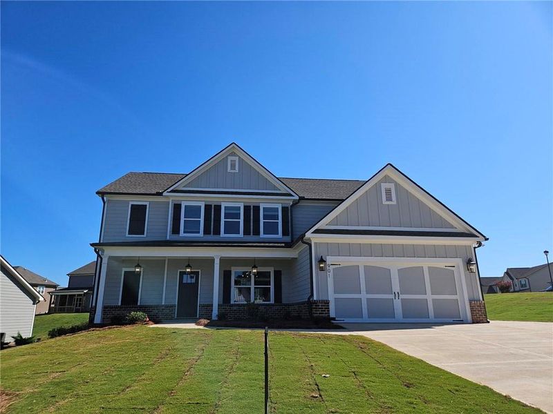 Front exterior of a new home in Calgary Downs, Winder, GA, highlighting curb appeal (Image 1).