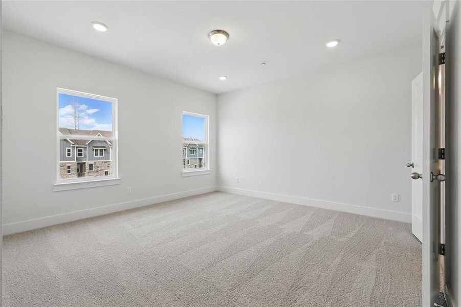 Spare room with light colored carpet and recessed lighting